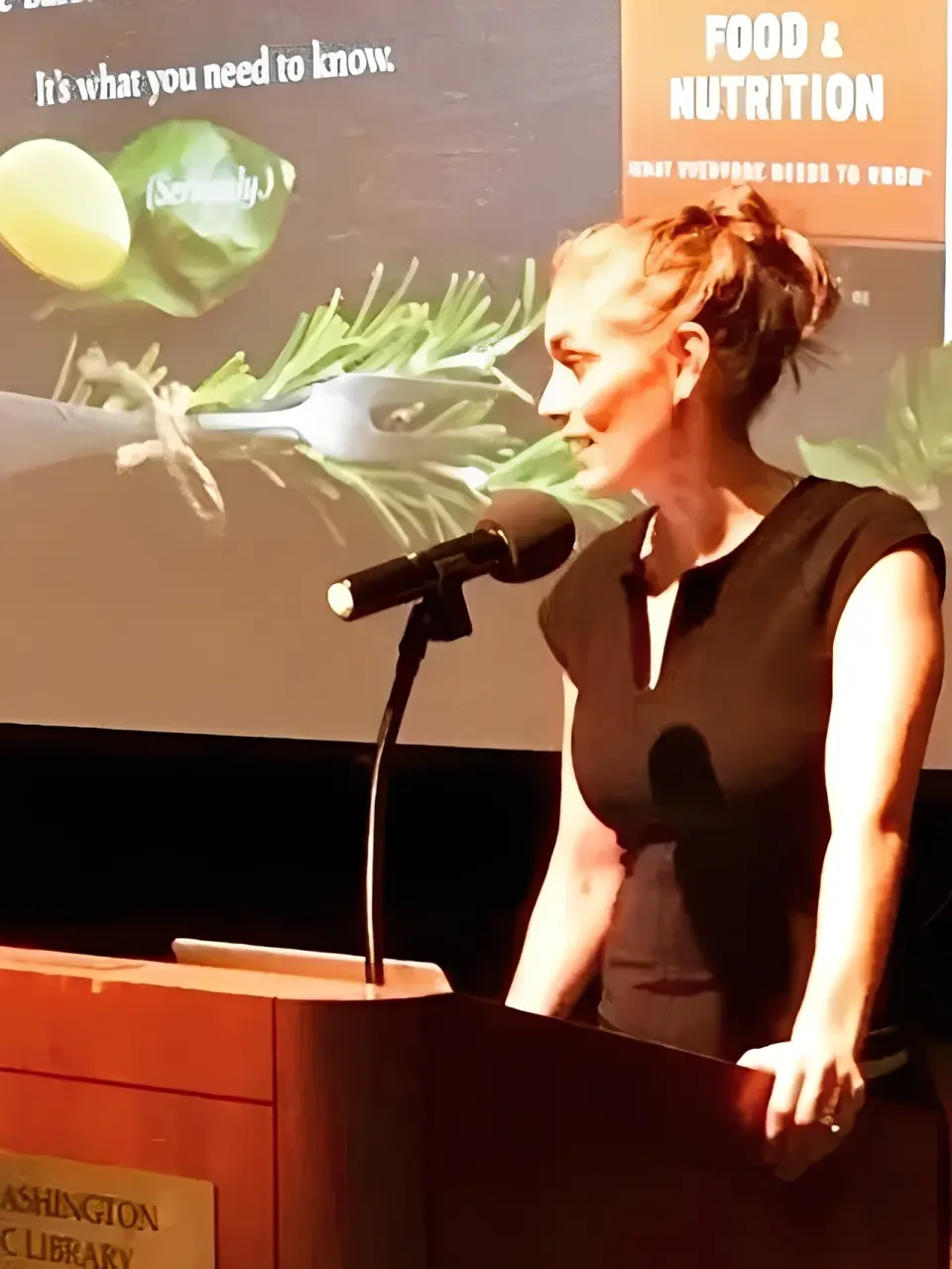 Speaker presenting on food and nutrition.