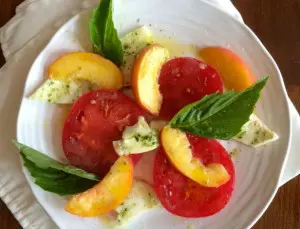 Fresh tomato and peach salad with basil and mozzarella.
