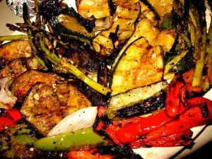 Grilled vegetables and meat on a platter.