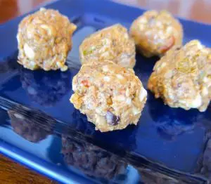 Close-up of almond butter energy bites on a blue plate.