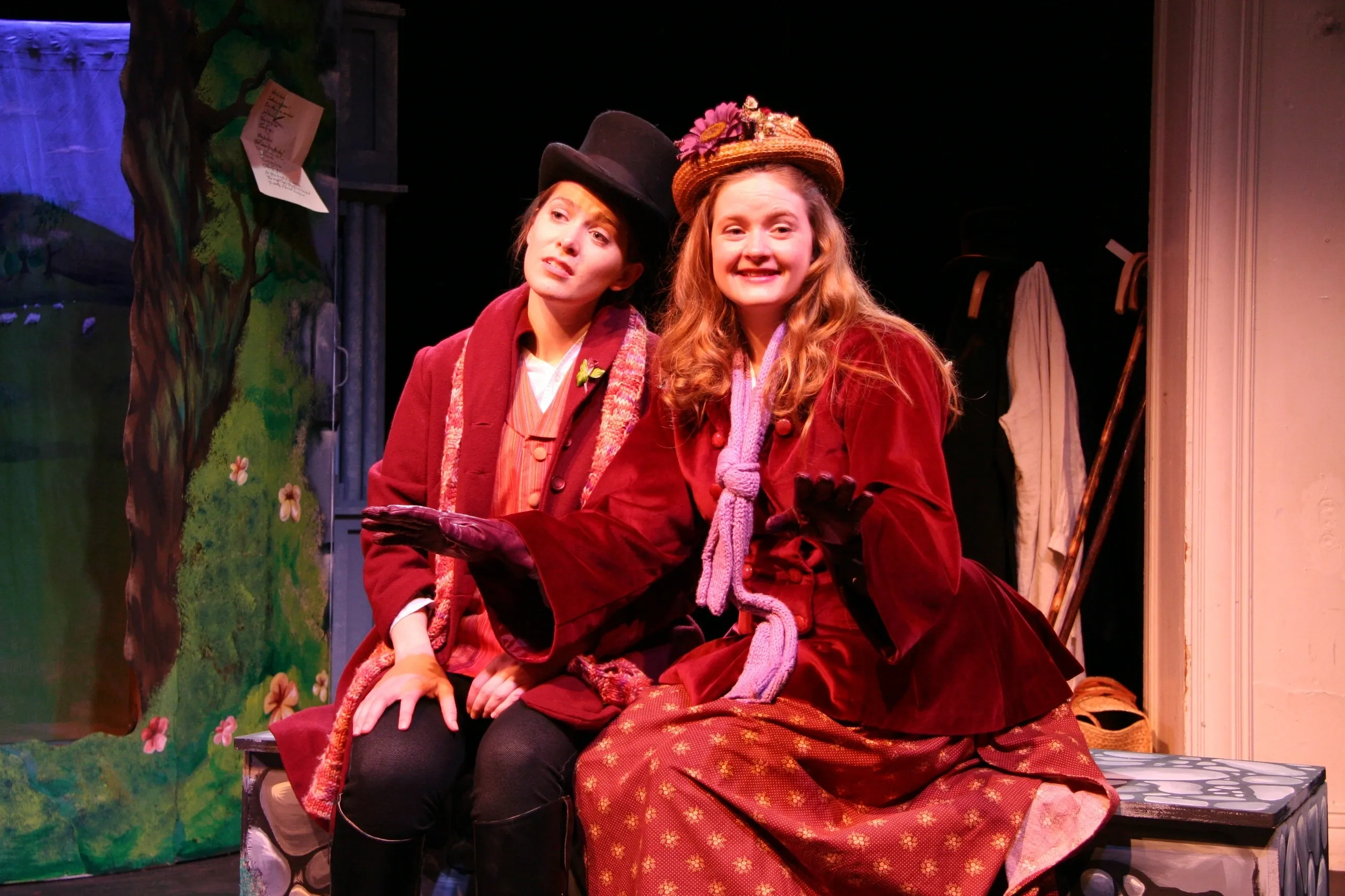 Two women in vintage costumes performing on stage.