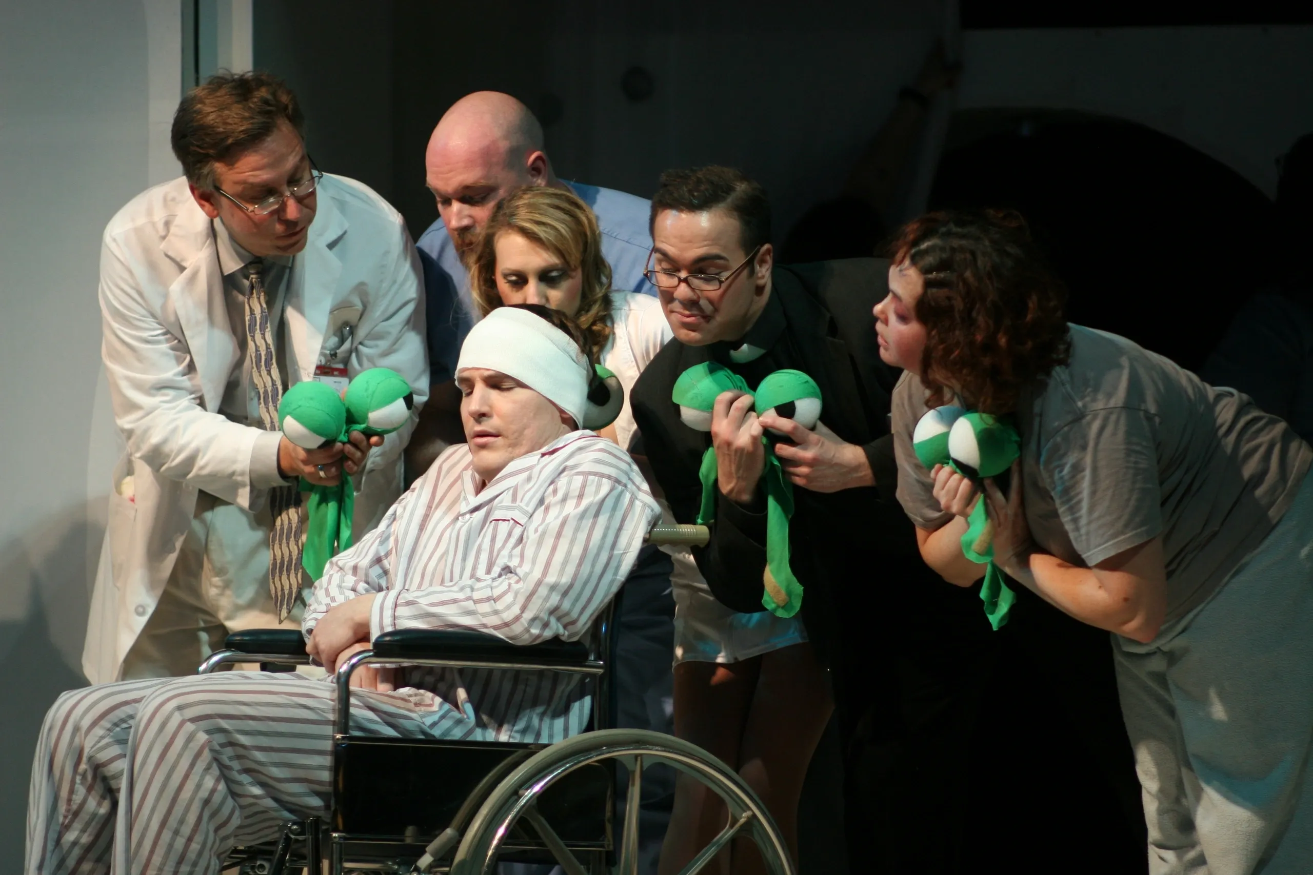 A group of people attentively interacting with a woman in a wheelchair.