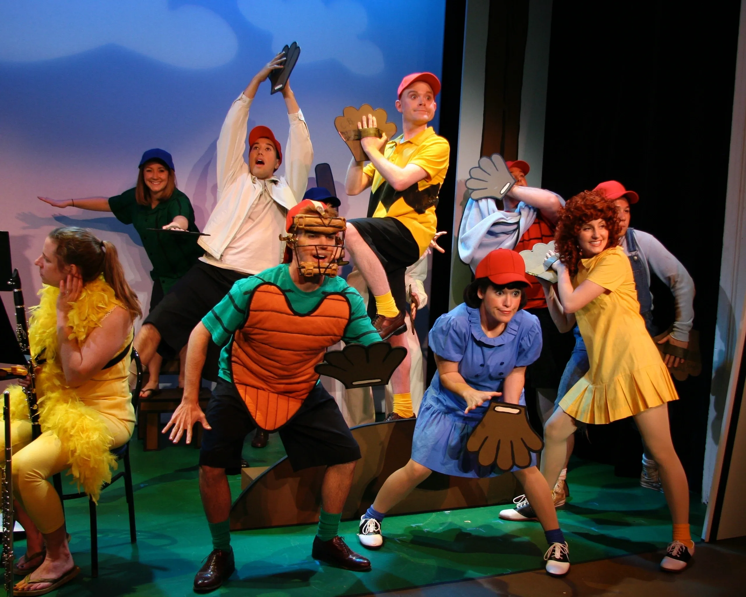 Children in colorful costumes performing a lively stage play.