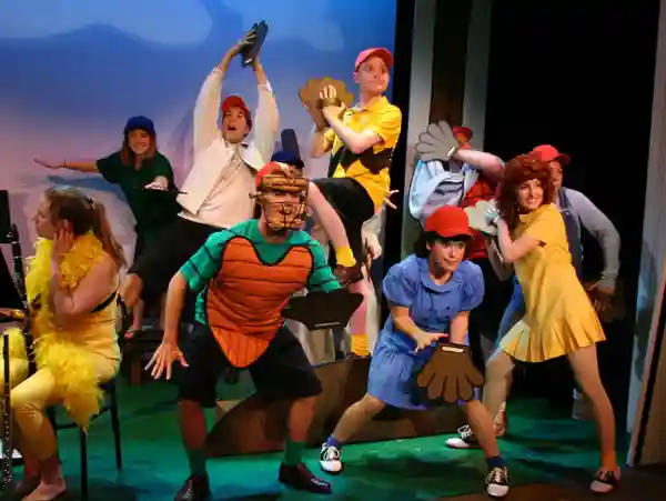Actors dressed as Pokémon characters performing on stage.