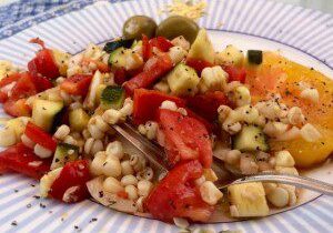 A colorful bean and vegetable salad on a plate.