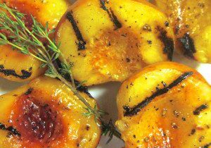 Grilled peaches with herbs and seasoning.