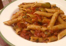 A plate of penne pasta with tomato sauce and olives.