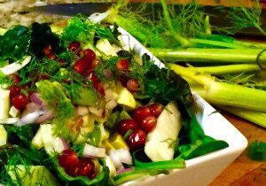 Fresh salad with vibrant greens and pomegranate seeds.