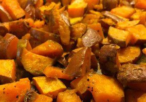 Close-up of roasted sweet potatoes with herbs.