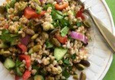 A colorful vegetable quinoa salad on a white plate.