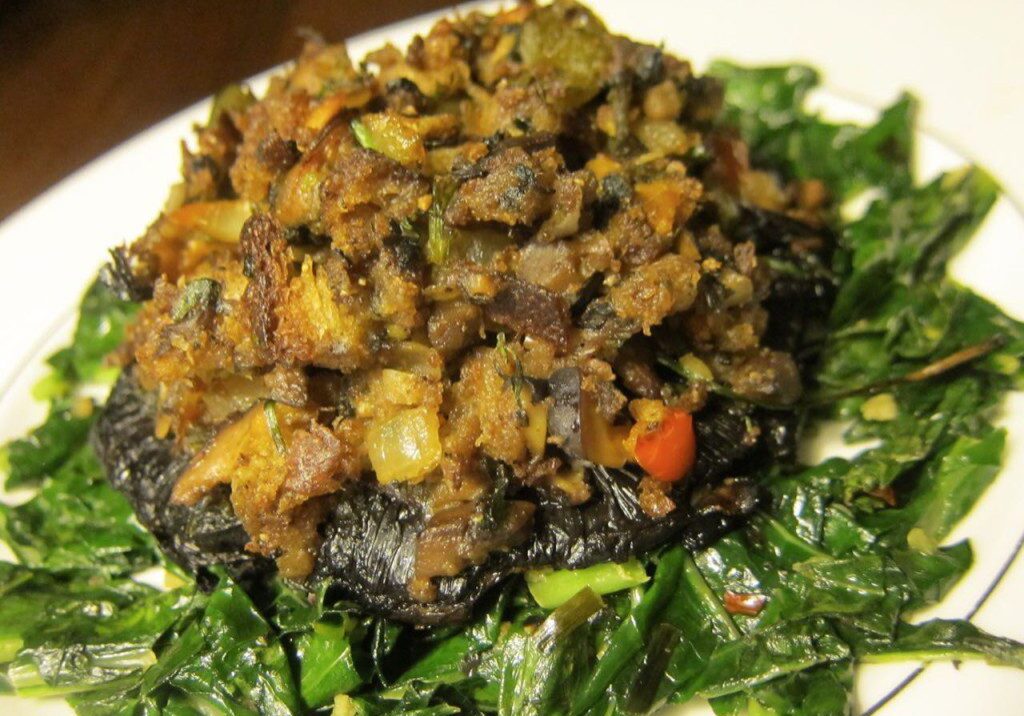 Savory sautéed mushrooms and vegetables on a bed of greens.