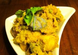 A bowl of flavorful Indian dal tadka garnished with coriander and spices.