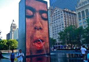 Large digital screen shows a close-up of a person smoking in an urban plaza.
