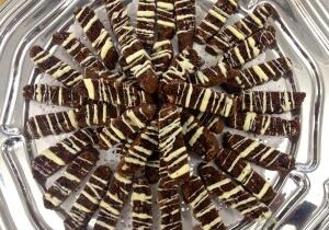 Chocolate and vanilla layered dessert bars arranged in a circle.