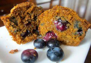 Blueberry muffins with fresh blueberries on a plate.