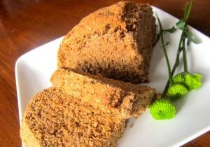 Sliced gingerbread cake on a white plate.