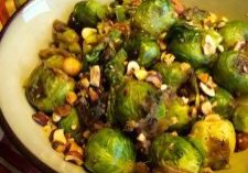 A bowl of roasted Brussels sprouts with nuts.