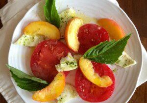 Fresh tomato and peach salad with basil and mozzarella.