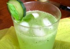 Refreshing cucumber drink with ice in a glass.