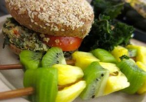 Close-up of a sandwich with fresh kiwi and pineapple slices.