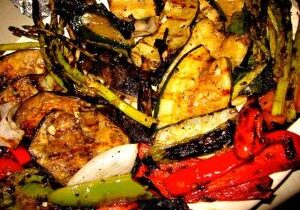 Grilled vegetables and meat on a platter.