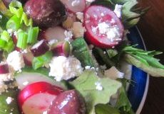 Fresh salad with radishes, grapes, and feta cheese.