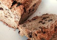 Sliced homemade raisin bread on a white plate.