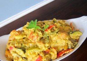 A colorful dish of mixed vegetables and spices served in a white bowl.