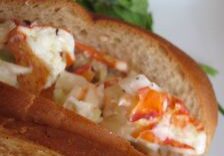 A lobster roll sandwich with chunks of lobster meat and mayonnaise.