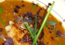 Seared scallops served on a rich, creamy sauce with herbs and crispy bits.