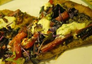 Close-up of two slices of vegetable pizza with cheese.