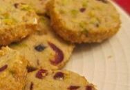 Close-up of homemade cookies with nuts and dried fruit on a plate.