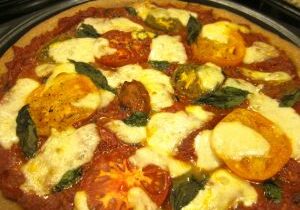 Delicious homemade pizza with fresh basil and melted cheese.