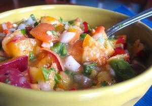 Colorful bowl of shrimp ceviche with vegetables.