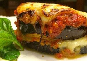 Delicious eggplant parmesan with melted cheese and basil garnish.