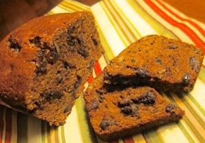 Close-up of two chocolate chip muffins on a striped cloth.