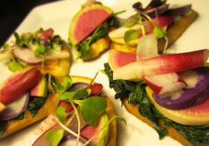 Gourmet appetizers featuring seared tuna and fresh microgreens on crisp toast.