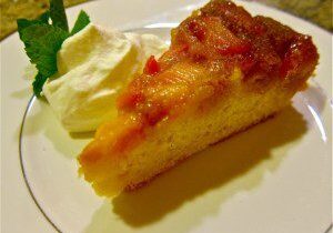 A slice of fruit tart with whipped cream on a plate.