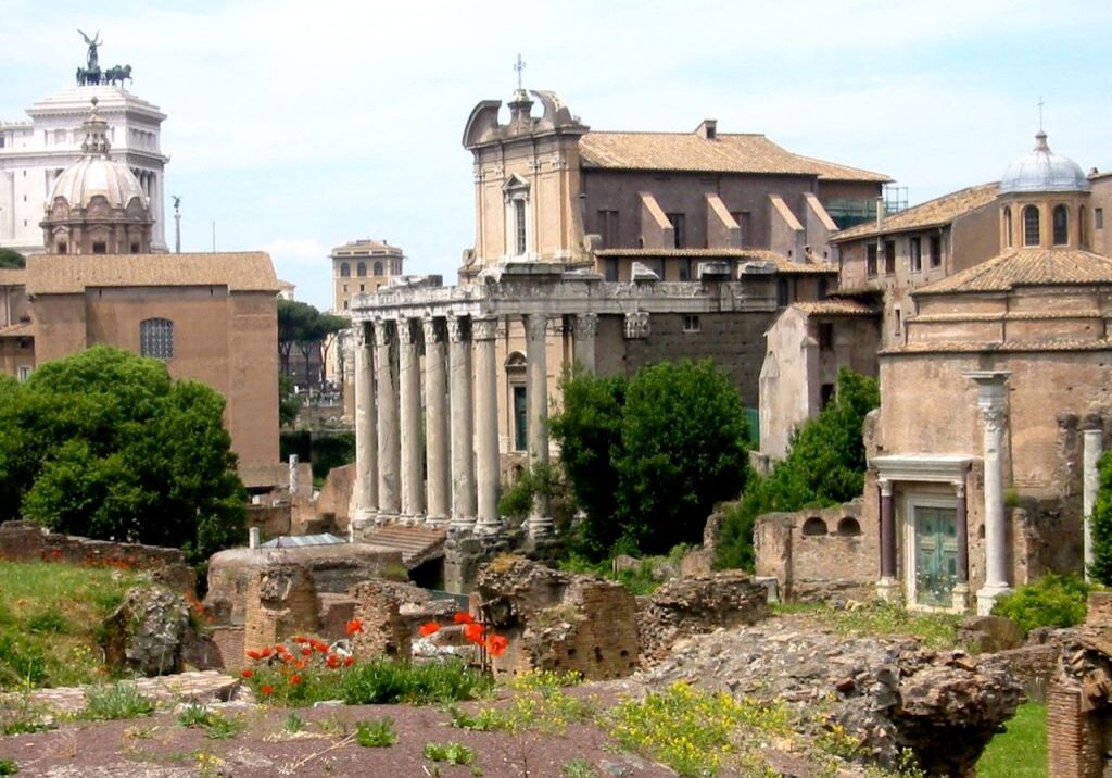 Ancient Roman ruins with classical columns and historic buildings.