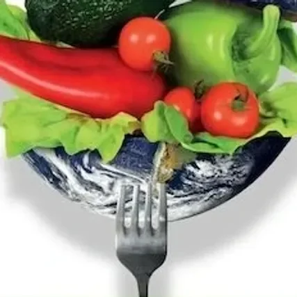Fresh vegetables on a fork with Earth in the background.