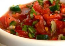 A bowl of fresh tomato salsa with herbs.