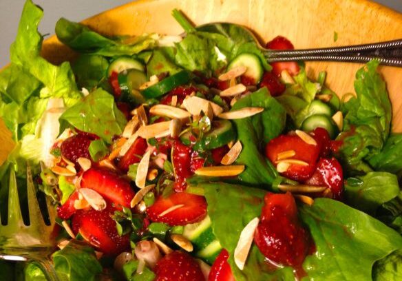 Fresh spinach salad with strawberries, pecans, and goat cheese.