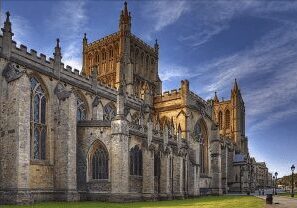 Historic Gothic cathedral with intricate stonework under a blue sky.