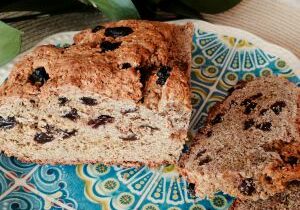 Freshly baked blueberry bread on a colorful plate.