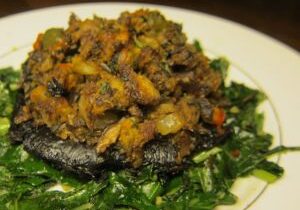 Stuffed portobello mushroom on sautéed greens.