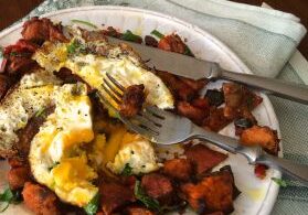 A plate with a poached egg and roasted vegetables.