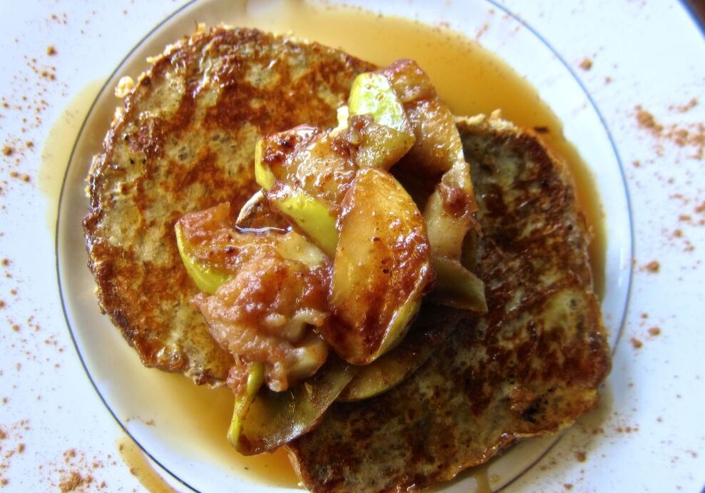 Delicious pancakes topped with caramelized bananas and syrup.